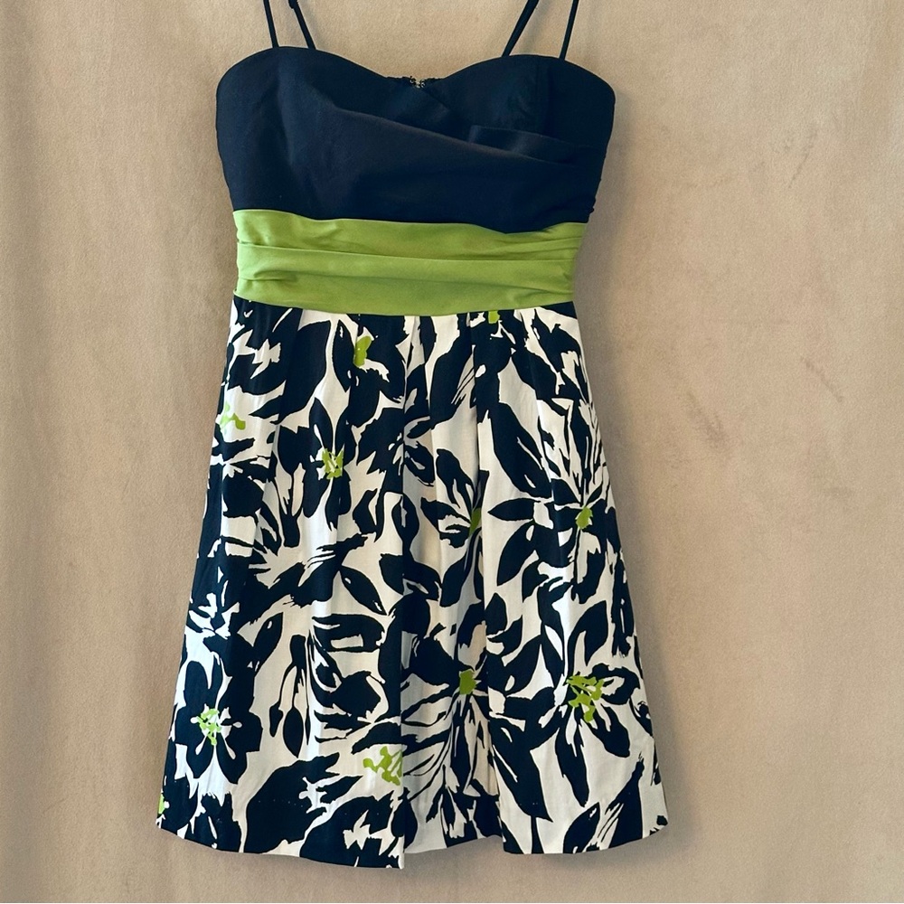 Black, white & green floral mini sundress with empire waist & adjustable straps.